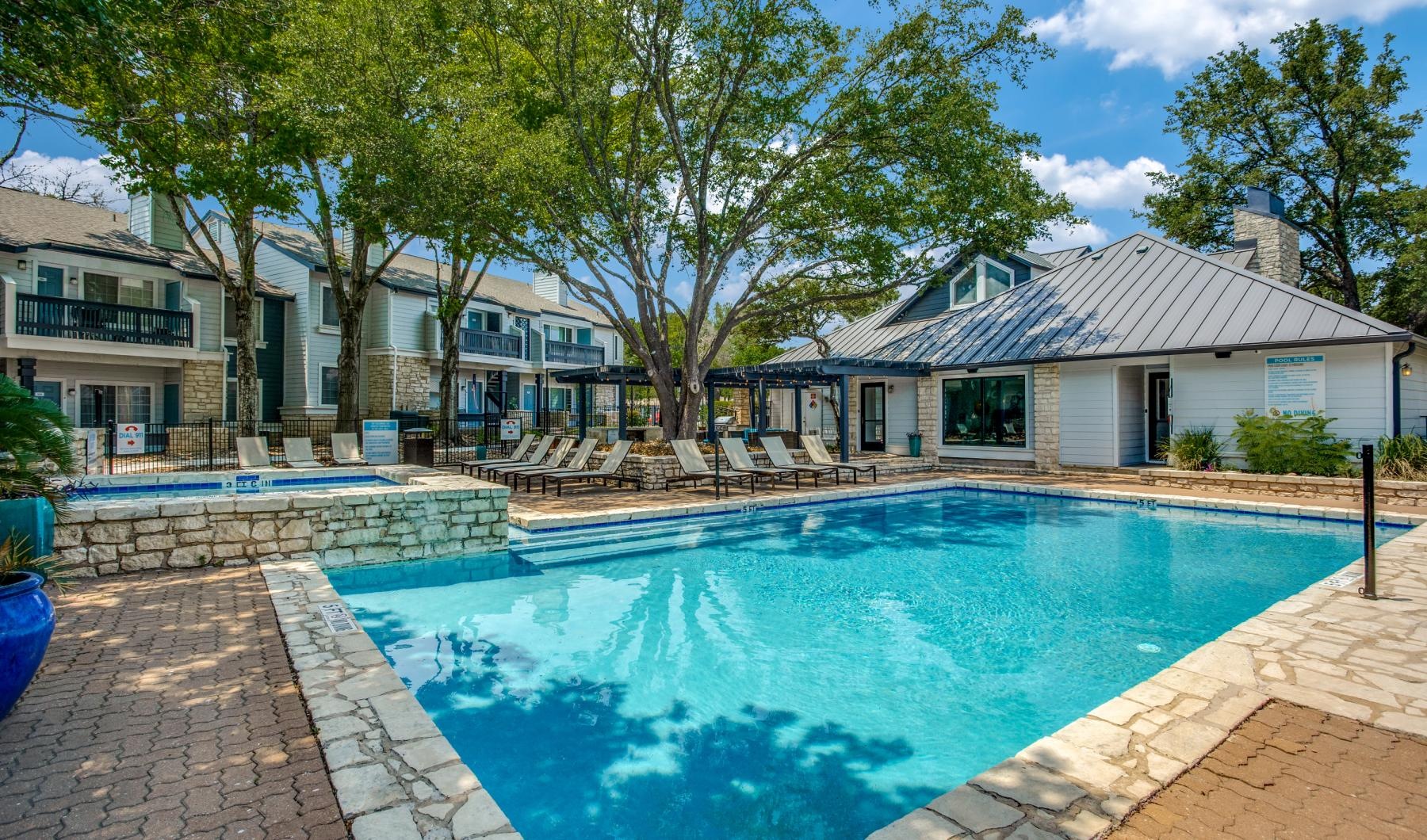 a swimming pool with a building behind it