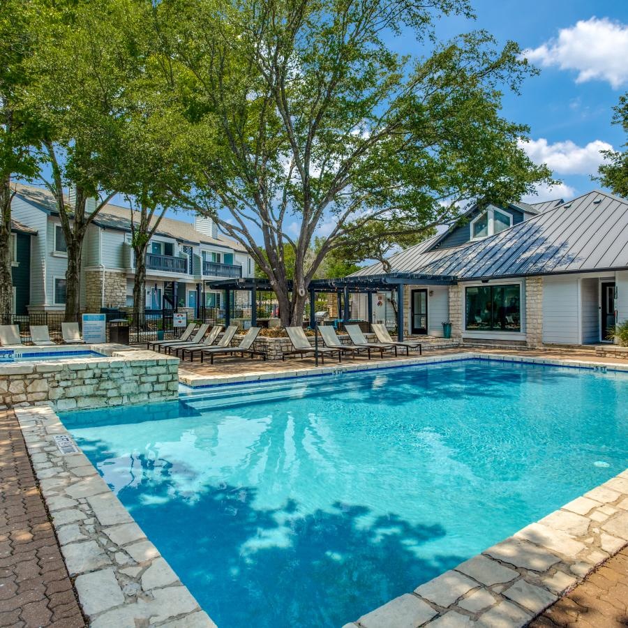 a swimming pool with a building behind it