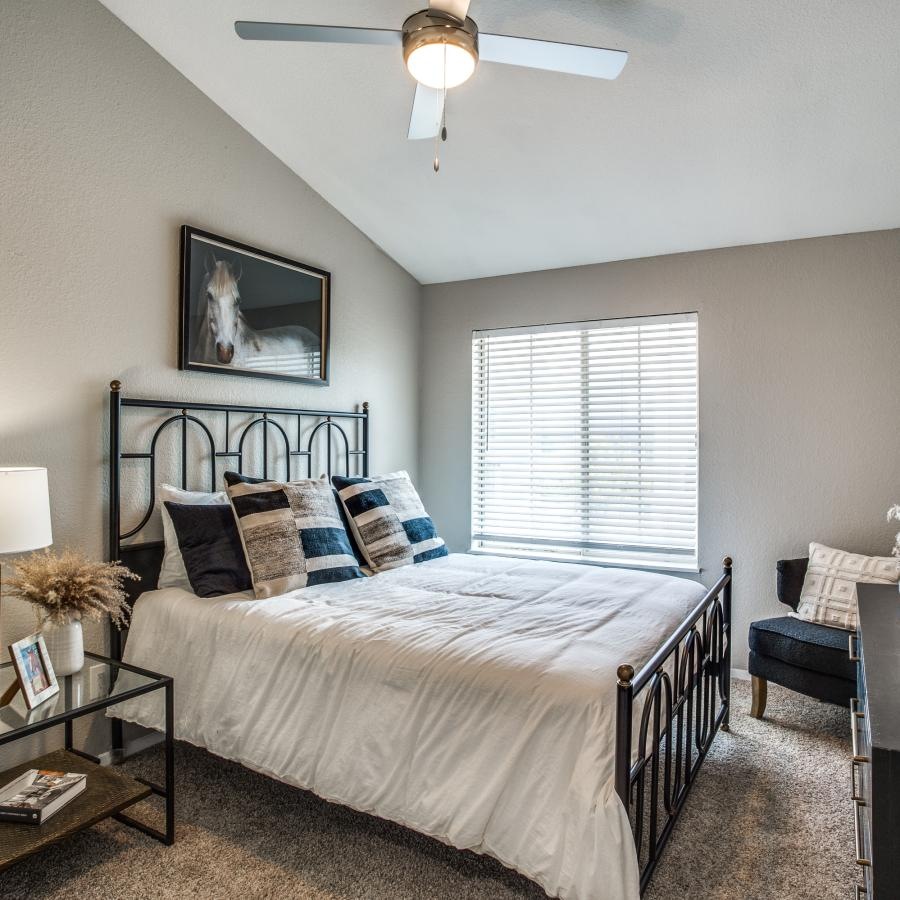 a bedroom with a bed and a mirror