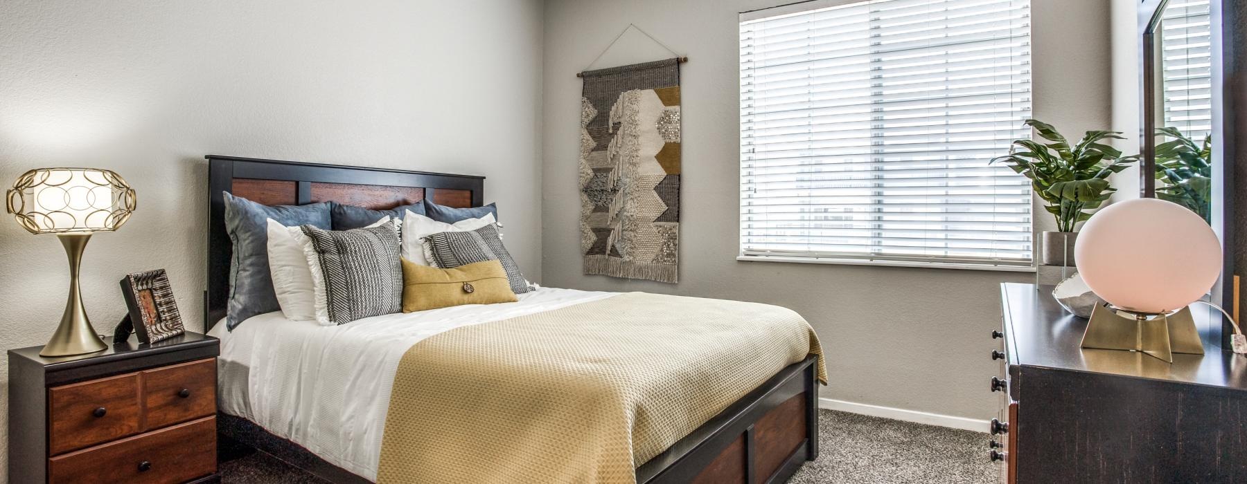 a bedroom with a bed and a lamp